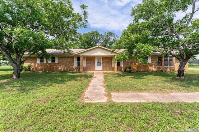 ranch-style home featuring a front yard