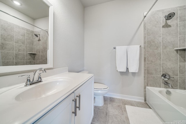 full bathroom featuring tile patterned flooring, vanity, toilet, and tiled shower / bath