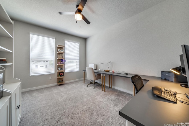 carpeted office space with ceiling fan