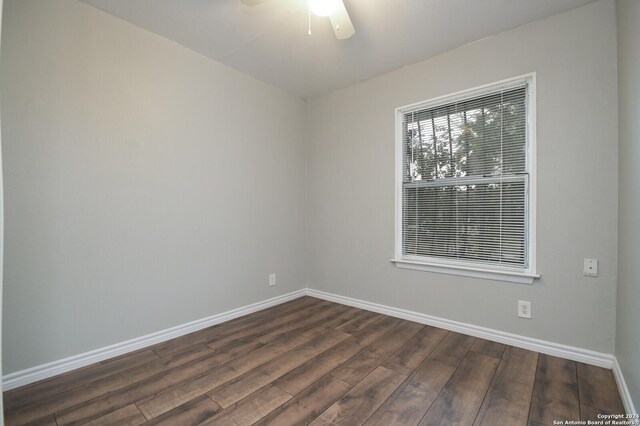 spare room with ceiling fan and dark hardwood / wood-style flooring