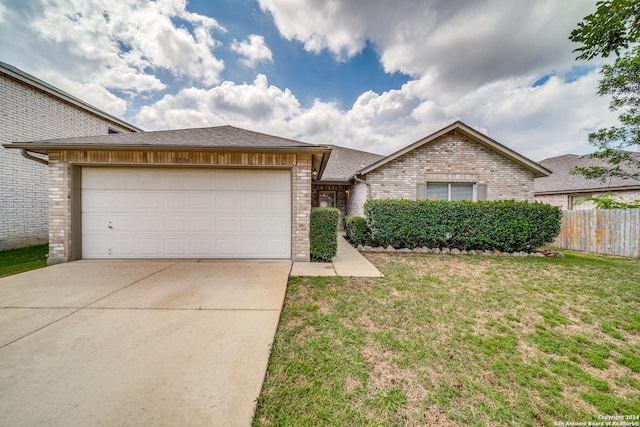 view of front of property featuring a garage and a front lawn