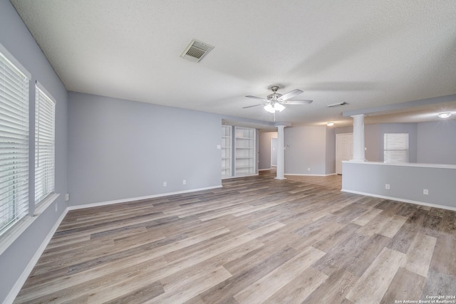 interior space featuring a textured ceiling, light hardwood / wood-style flooring, ceiling fan, and a healthy amount of sunlight