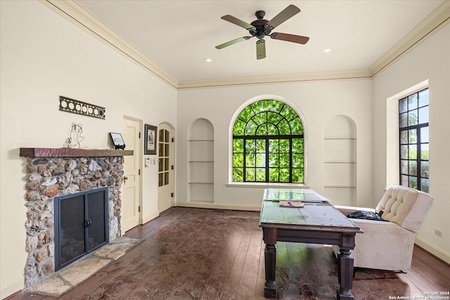 office featuring built in shelves, a healthy amount of sunlight, and dark hardwood / wood-style floors