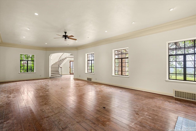 unfurnished living room with hardwood / wood-style flooring, crown molding, and ceiling fan