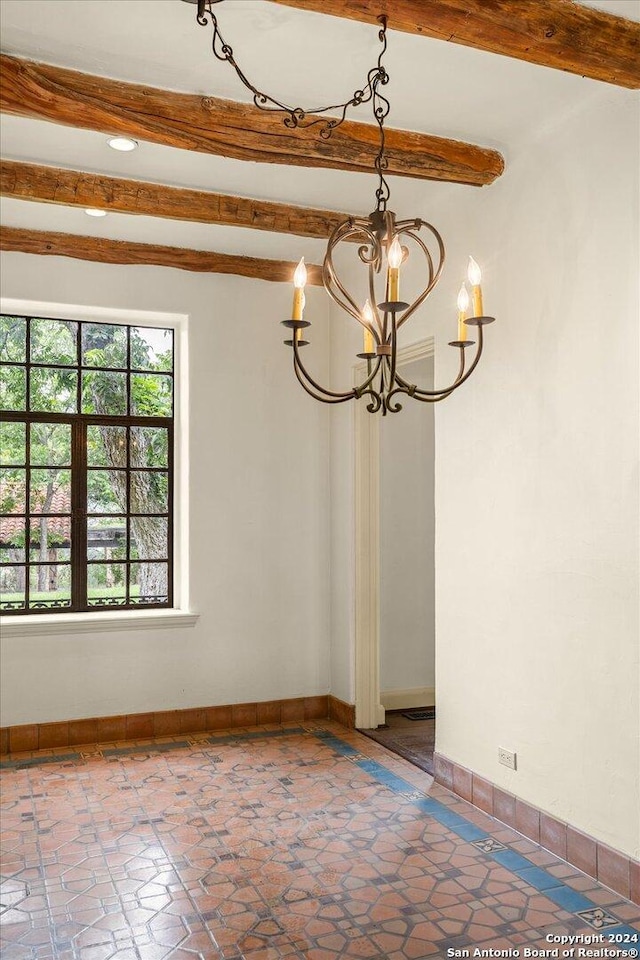 unfurnished dining area with beamed ceiling and a chandelier