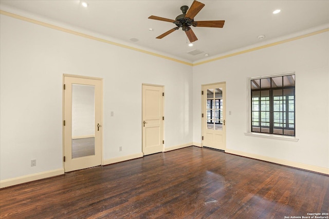 empty room with dark hardwood / wood-style flooring, ornamental molding, and ceiling fan