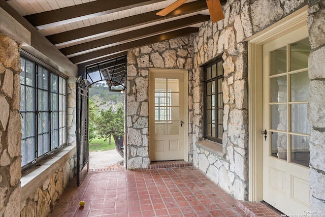 entryway featuring lofted ceiling with beams