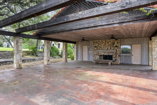 view of patio / terrace with an outdoor stone fireplace and ceiling fan