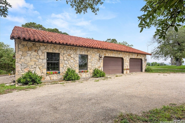 mediterranean / spanish-style house featuring a garage