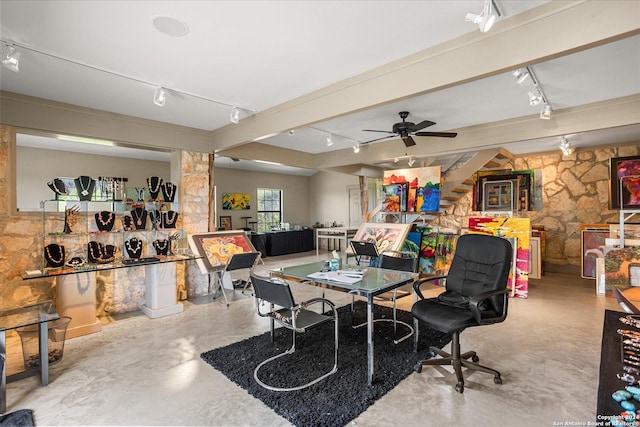 dining room featuring rail lighting, concrete floors, and ceiling fan