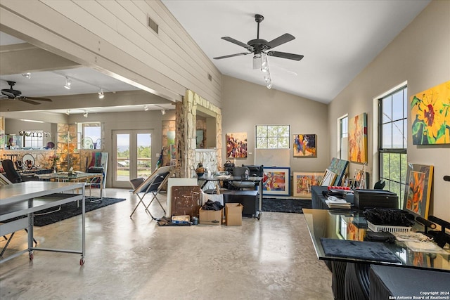 misc room featuring concrete flooring, high vaulted ceiling, rail lighting, ceiling fan, and french doors