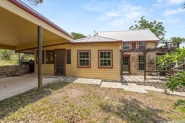 view of front of property with a pergola and a patio area