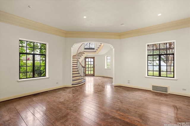 empty room featuring crown molding and hardwood / wood-style flooring