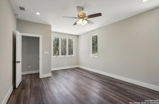 unfurnished bedroom with ceiling fan and dark hardwood / wood-style floors