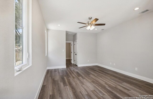 unfurnished room with dark hardwood / wood-style floors and ceiling fan