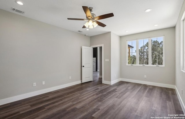 unfurnished bedroom featuring ceiling fan and dark hardwood / wood-style floors