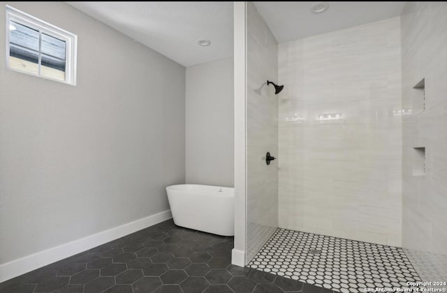 bathroom featuring tile patterned flooring and plus walk in shower