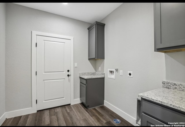 clothes washing area featuring hookup for a washing machine, cabinets, dark hardwood / wood-style floors, and hookup for an electric dryer