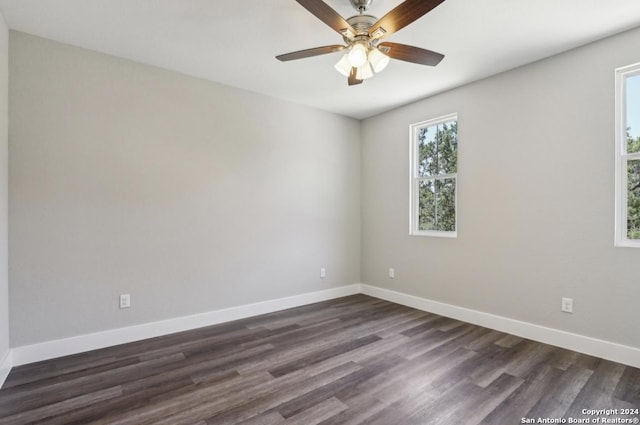 empty room featuring dark hardwood / wood-style flooring and ceiling fan