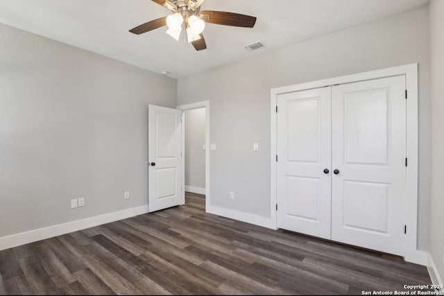 unfurnished bedroom with a closet, ceiling fan, and dark wood-type flooring