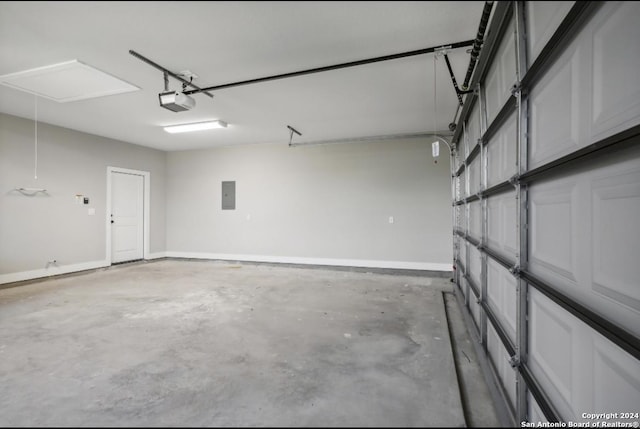 garage with electric panel and a garage door opener