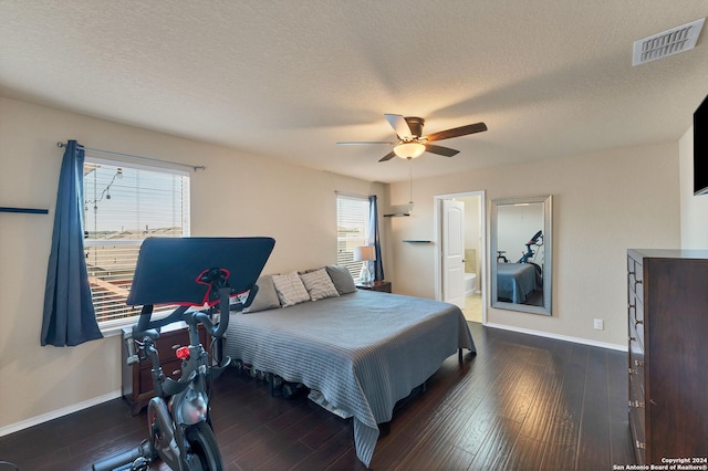 bedroom with ceiling fan, dark hardwood / wood-style floors, ensuite bathroom, and multiple windows