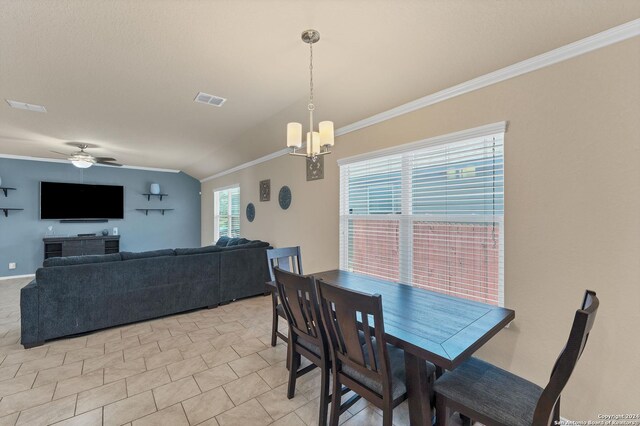 dining room with ceiling fan with notable chandelier, vaulted ceiling, and ornamental molding