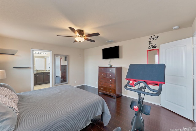 bedroom featuring dark hardwood / wood-style floors, ensuite bath, and ceiling fan