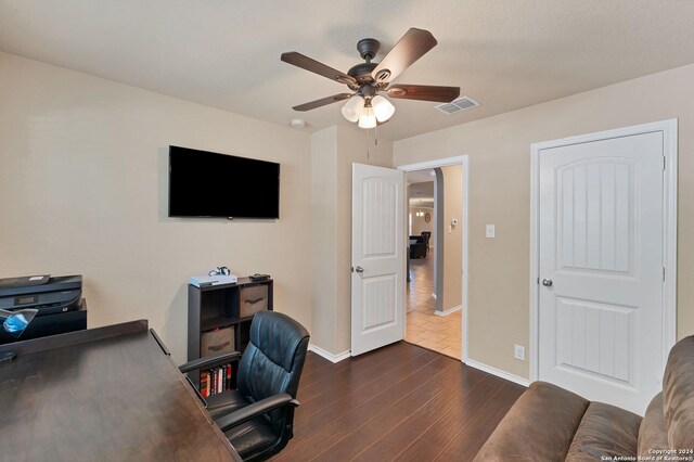 office with dark hardwood / wood-style flooring and ceiling fan