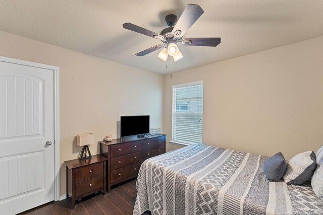 bedroom with ceiling fan and dark hardwood / wood-style flooring