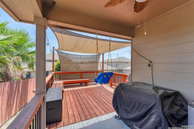 wooden deck with ceiling fan and a grill