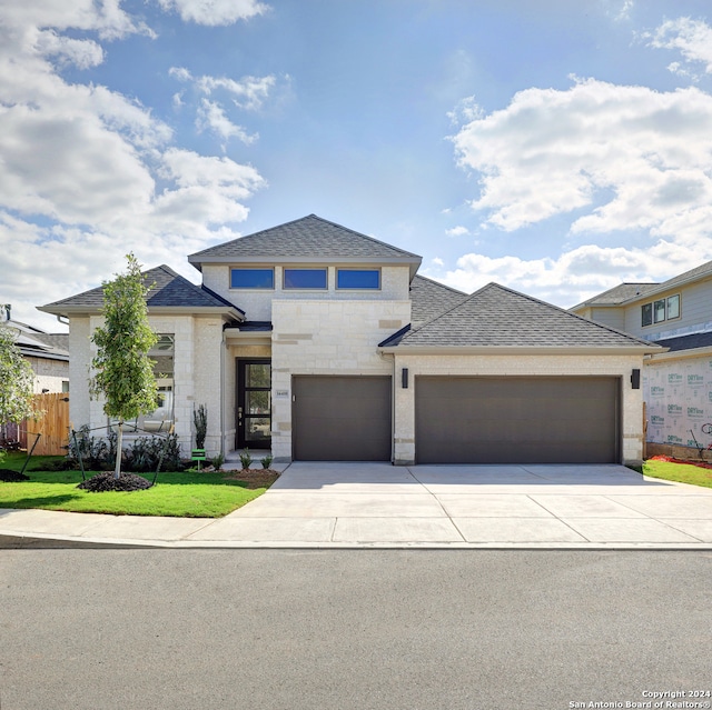 prairie-style house featuring a garage