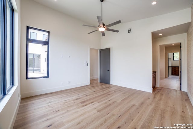 spare room featuring ceiling fan, vaulted ceiling, and light wood-type flooring