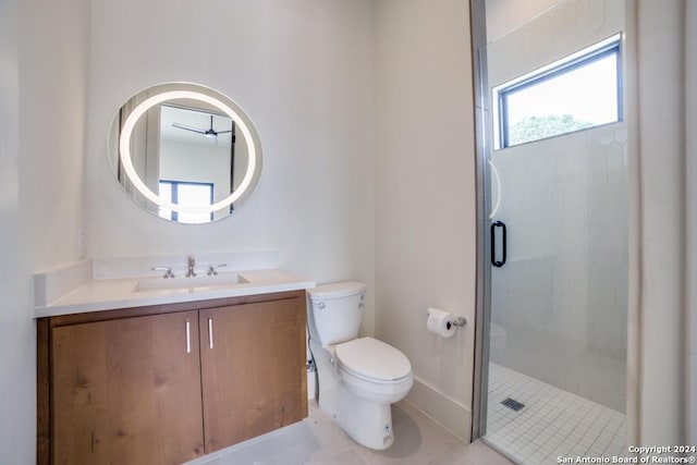 bathroom featuring tile patterned floors, toilet, a shower with shower door, and vanity