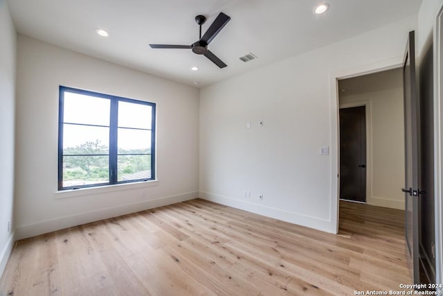 empty room featuring ceiling fan and light hardwood / wood-style flooring