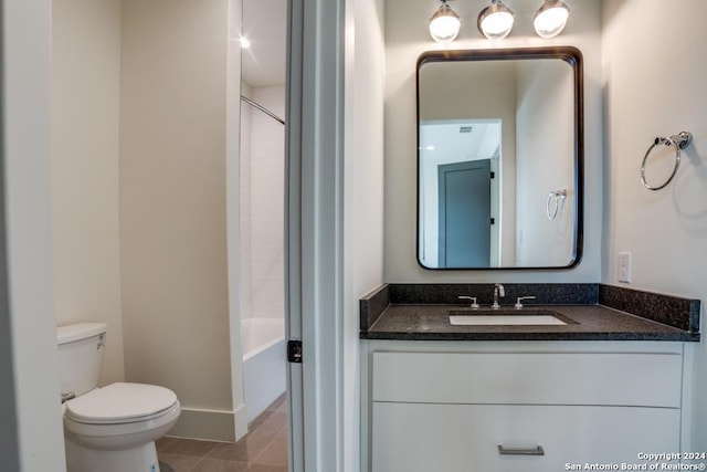 full bathroom featuring vanity, tile patterned floors, toilet, and washtub / shower combination