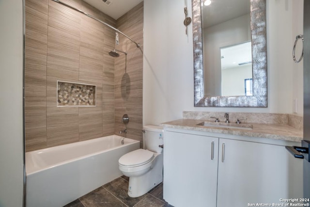 full bathroom with tile patterned floors, vanity, toilet, and tiled shower / bath combo