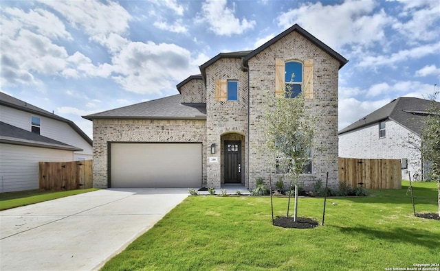 view of front of house featuring a front yard and a garage