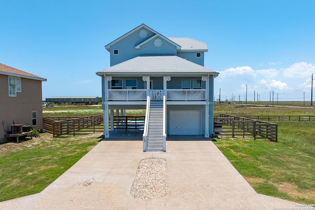 view of front facade with a garage, covered porch, and a front lawn