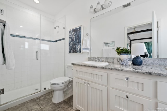 bathroom with vanity, tile patterned flooring, toilet, and walk in shower