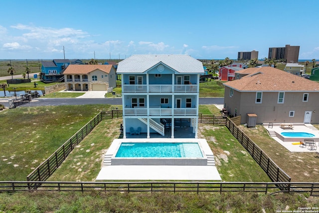 back of property with a fenced in pool, a patio, a balcony, and central air condition unit