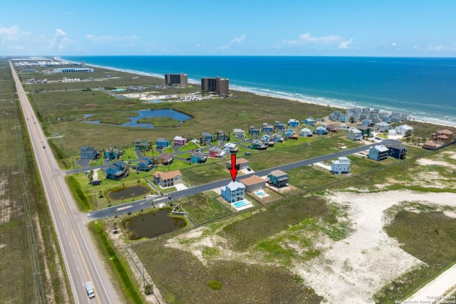 birds eye view of property with a water view and a view of the beach