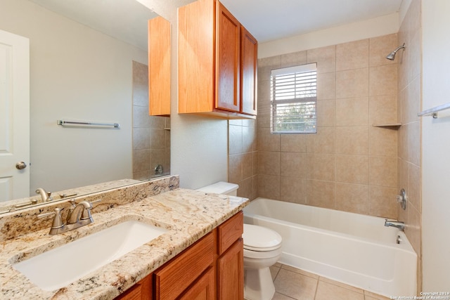 full bathroom featuring tile patterned floors, tiled shower / bath combo, toilet, and vanity