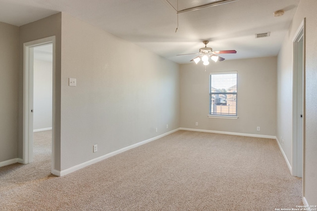 carpeted spare room featuring ceiling fan