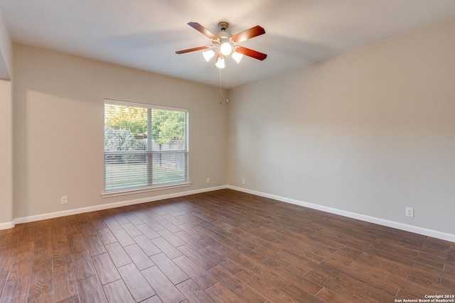 unfurnished room with dark hardwood / wood-style flooring and ceiling fan