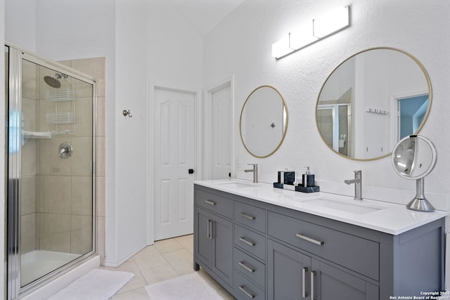 bathroom featuring vanity, a shower with door, and tile patterned floors