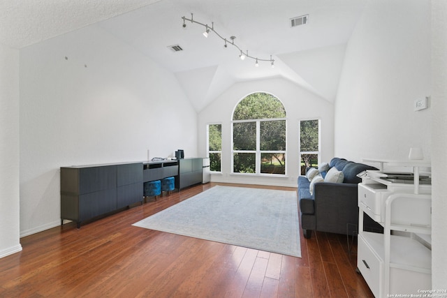 living room with vaulted ceiling and dark hardwood / wood-style flooring