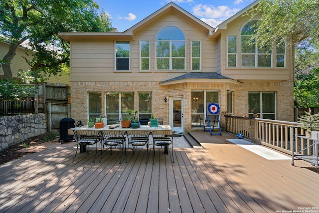 back of property featuring a wooden deck