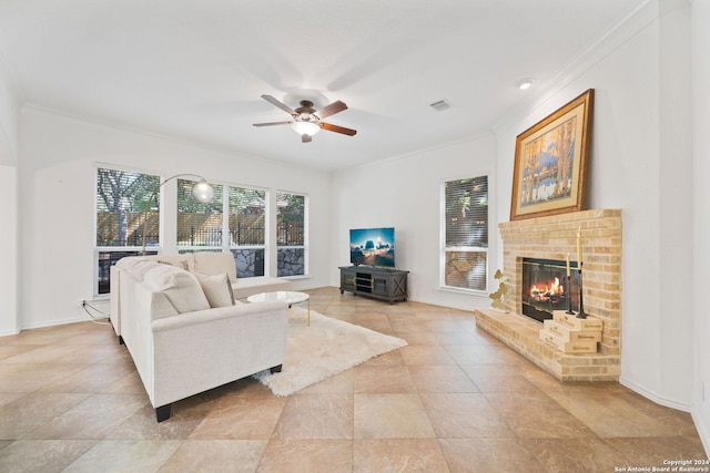 living room featuring a brick fireplace, ornamental molding, and ceiling fan