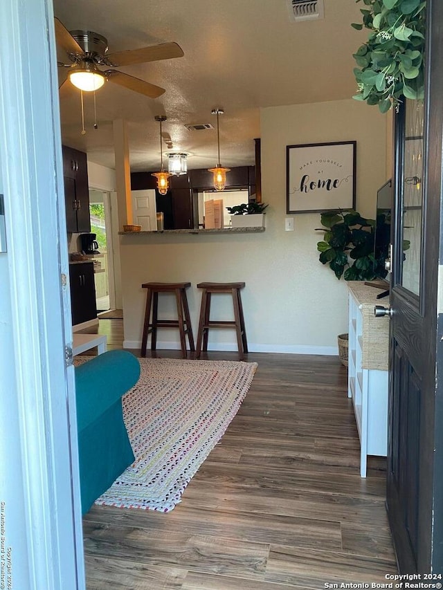 dining space with dark hardwood / wood-style floors and ceiling fan